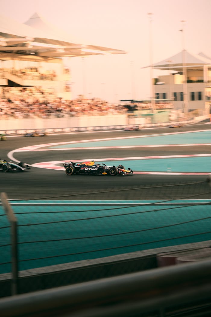 Action-packed Formula 1 race at Yas Marina Circuit in Abu Dhabi, captured at sunset.