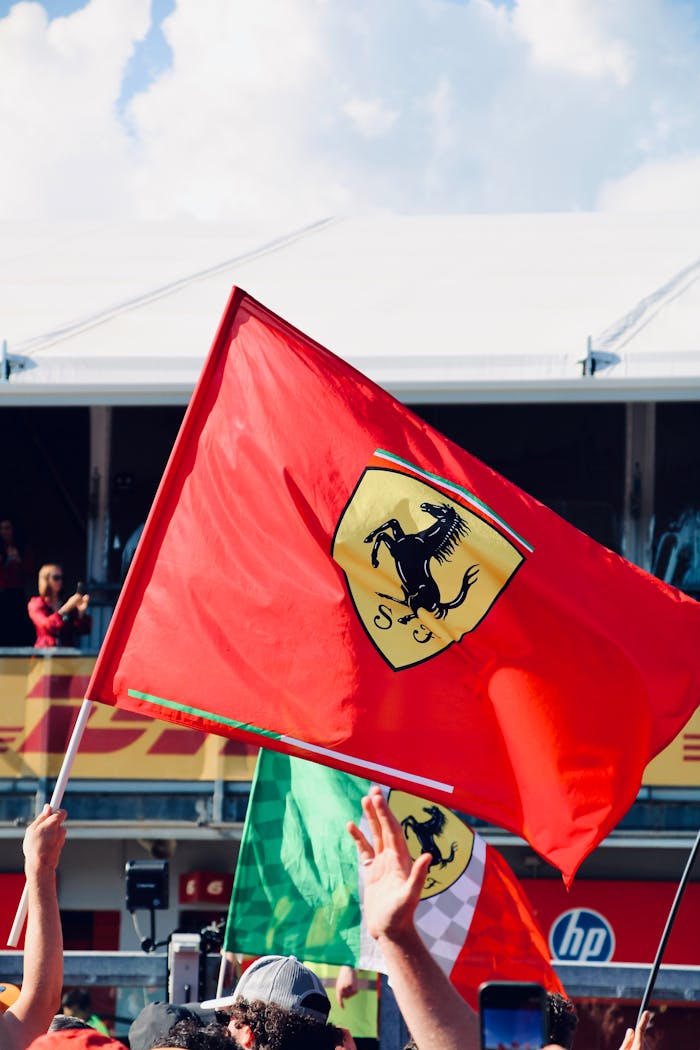 Vibrant scene with Ferrari flag waving during Formula 1 race at Imola, Italy.